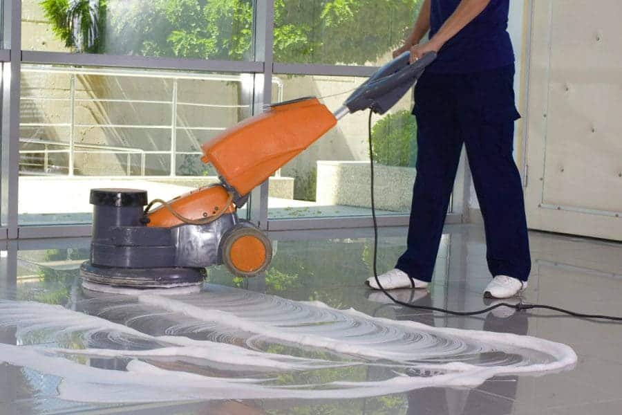 floor care services orlando - technician auto-scrubbing a commercial tile floor